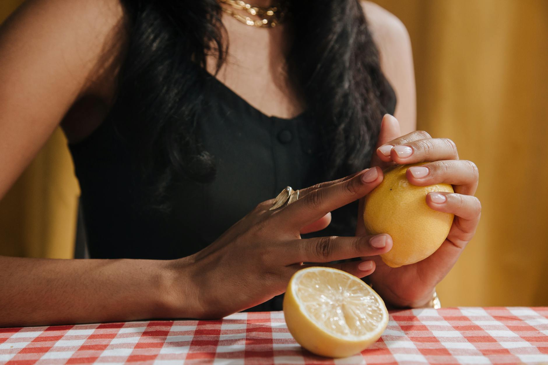 Woman holding a fresh lemon, symbolizing renewal and gentle healing