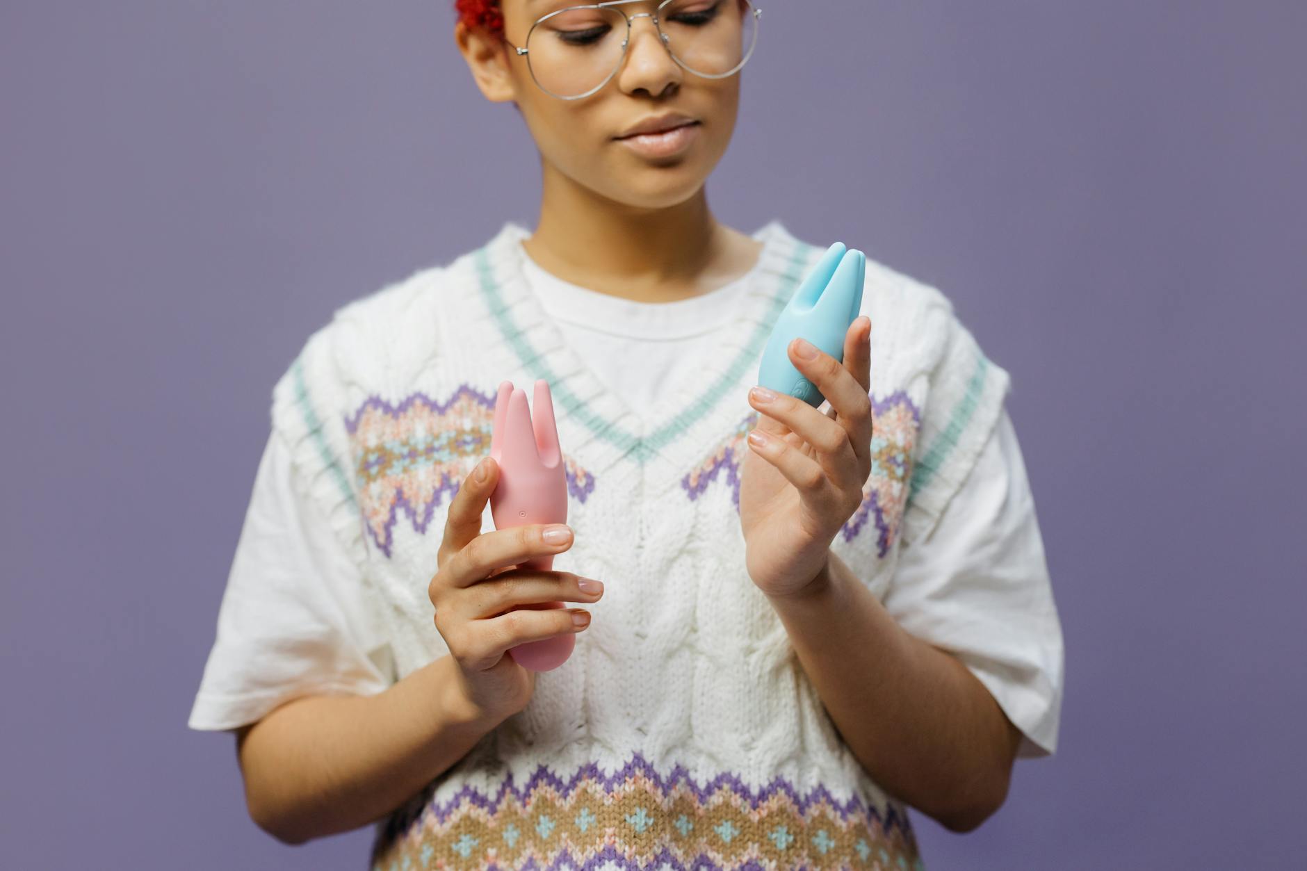 Woman holding a blue clitoral vibrator, symbolizing pleasure and sexual wellness while managing medication side effects